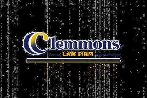 Clemmons Law Firm logo featuring a crescent moon symbol in blue and gold on a black textured background